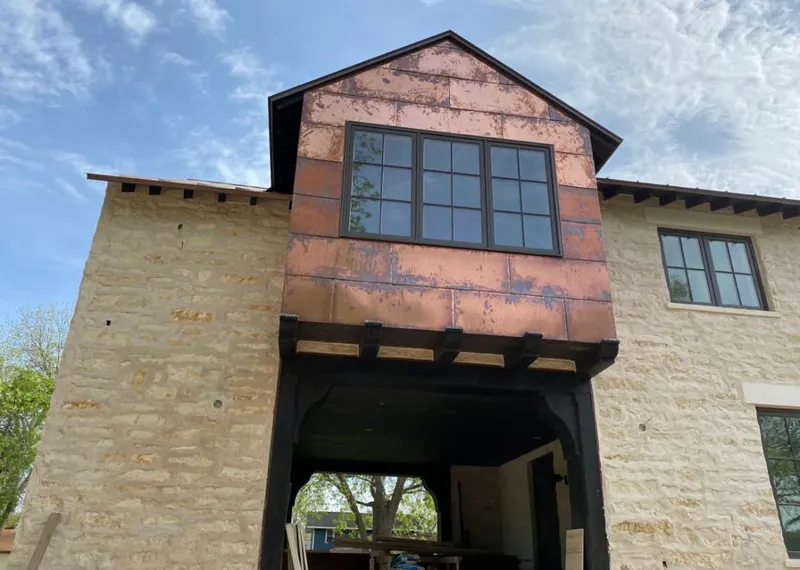 Copper metal panel facade on a stone building for Skylight Installation in Kilgore