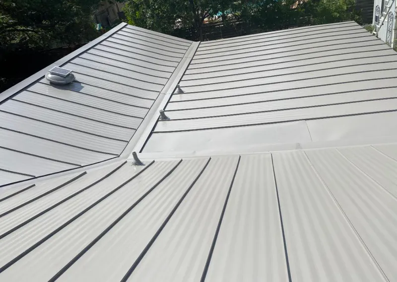 Solar attic fan installed on a metal roof for Roof Ventilation in Kilgore