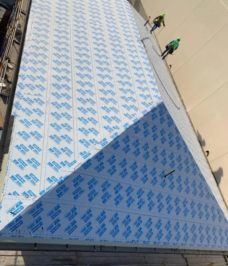 Professional roofers installing underlayment on a metal roof in Kilgore